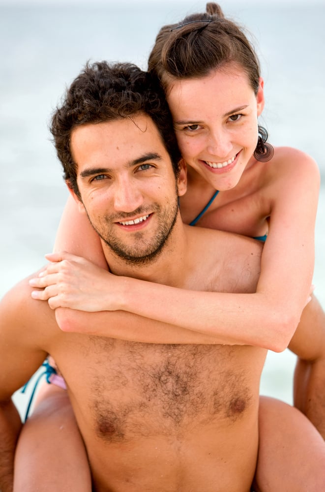 happy couple at the beach during vacation